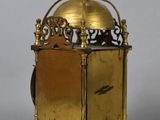 an antique brass clock with a dome on top of it