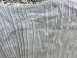 the back of a woman ' s white dress with a lace overlay