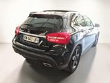 the rear of a black mercedes gla parked in a white room