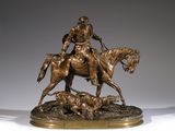 bronze statue of a man on a horse with a dog