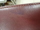 a close up of a brown leather wallet with stitching on it
