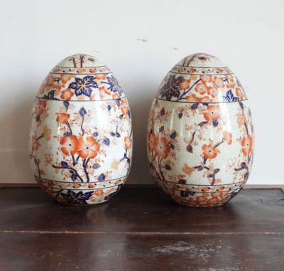 deux vases ornés de motifs orange et bleus, posés sur une table