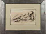 painting of a nude woman laying down in a frame on a table