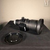 a camera sitting on top of a speaker on a table