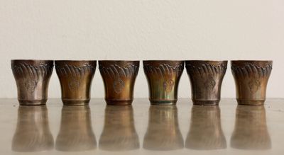 quatre verres à shot alignés sur une table