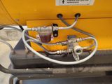 a close up of a machine with a hose attached to it