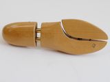 a close up of a wooden shoe with a pair of scissors on it