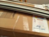 a man that is moving a box on a carton