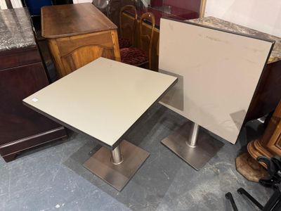 two tables that are sitting next to each other on the floor