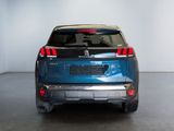 the rear end of a blue suv parked in a garage