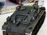 a toy tank that is sitting in front of a box