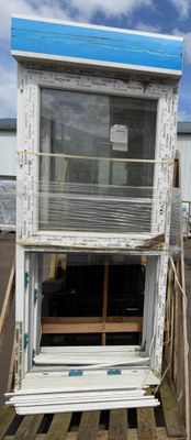 a window that is sitting on a pallet in front of a building