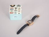 a watch that is laying on a table next to a box