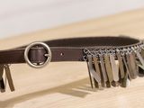 a brown belt with a bunch of metal spikes on it
