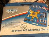 a box of tools sitting on top of a bed