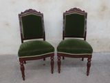 pair of green velveted chairs with wooden legs and a green upholstered seat