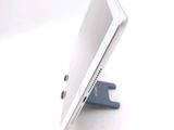 a tablet computer sitting on a stand on a white surface