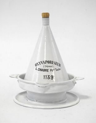 a white vase with a wooden lid on a saucer