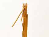 a wooden sculpture of a person holding a toothbrush