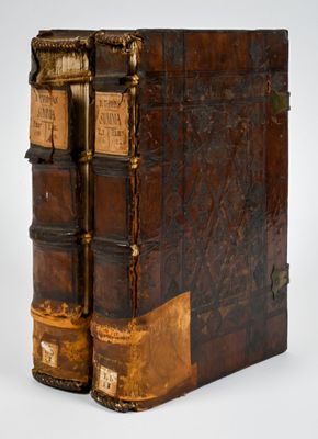 an old book with two books on top of each other