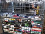 a metal cart with many books on it in a warehouse