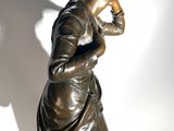 statue of a woman with a bird on her head