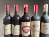 several bottles of wine are lined up on a table