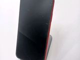 a phone that is sitting on a stand on a table