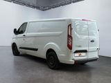 the back of a white van parked in a large room