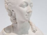 white marble bust of a woman with braids and braid hair