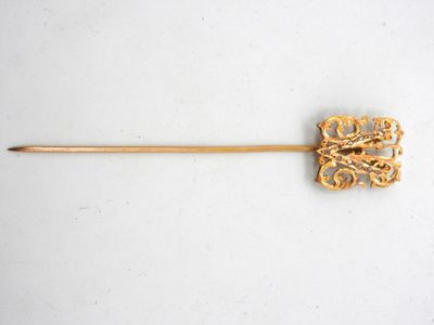an image of a gold stick with a flower design on it