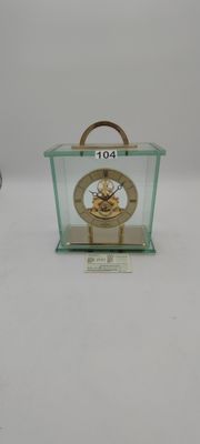 a small glass case with a clock inside of it