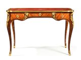 a small wooden table with a red top and gold accents