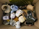 a cardboard box filled with many different types of vases