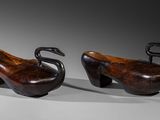 pair of wooden shoes with a swan on each of them