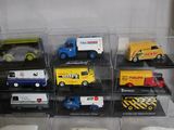 many different types of toy trucks in a display case