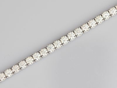 a close up of a diamond bracelet on a table