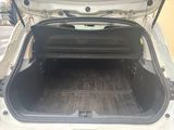 a trunk of a white car with its trunk open