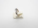 a close up of a silver ring on a white surface