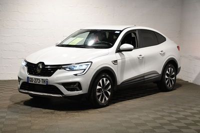 the white car is parked in a garage with a checkered floor