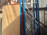 a pile of boxes and pallets in a warehouse