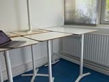 a laptop sitting on a desk in an empty room