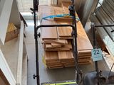 a lawn mower that is sitting on the floor next to a pile of wood
