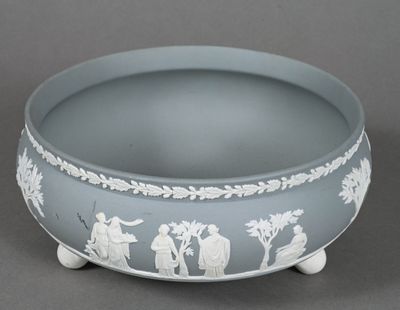 a blue bowl with white designs on it on a gray surface