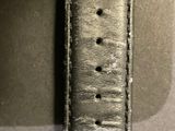 a close up of a watch with a leather band