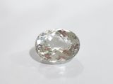 a close up of a white diamond on a white surface