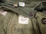 a close up of a military jacket with a tag on it