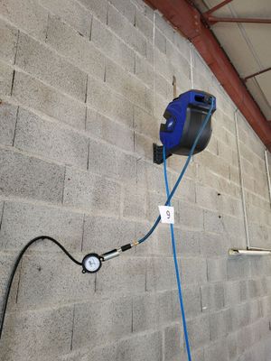 a blue hose attached to the wall of a building