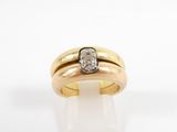 a close up of a gold ring with a diamond on top of it