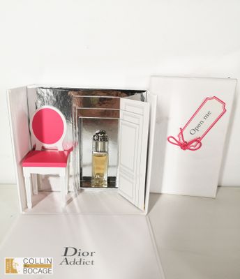 une chaise rose devant une porte devant laquelle se trouve une chaise rose